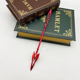 Red anime-style zinc alloy spear replica on stacked Hamlet books, collectible display