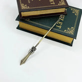 Anime-style zinc alloy weapon replica collectible sword on stacked vintage books