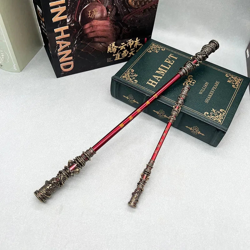 Anime-style red zinc alloy weapon replicas with intricate detailing displayed on a Hamlet book