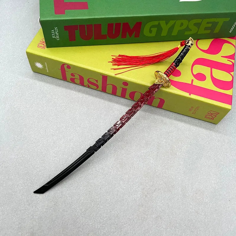 Anime-style zinc alloy katana replica with red tassel on books, BlacksmithSONG collectible.