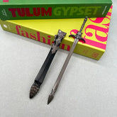 Anime-style 1:6 zinc alloy sword replica with detailed sheath on a tabletop, BlacksmithSONG collectible.
