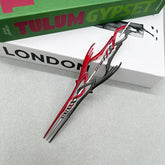 Anime-style red and silver zinc alloy weapon replica on books, collectible display by BlacksmithSONG