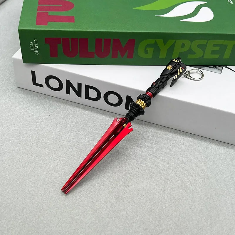 Anime-style zinc alloy red and black weapon replica keychain on books, BlacksmithSONG collectible.