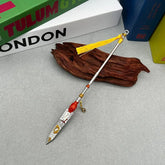 Anime-style 1:6 zinc alloy spear replica with yellow tassel, displayed on wood, BlacksmithSONG collectible.