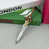 Anime-style zinc alloy sword replica with ornate gold hilt, displayed on books