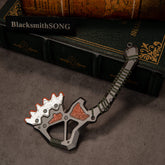 War Club replica (15cm die-cast zinc alloy patu) — silver crest edged in orange on a gunmetal frame, by BlacksmithSONG.