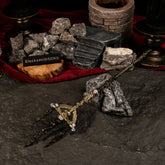 Mohgwyn's Sacred Spear replica resting on dark rocks and blood-red velvet cloth, surrounded by black ritual candles and a miniature stone altar.