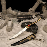 Catspaw Dagger metal replica unsheathed, resting on a dark rock surrounded by artificial snow, broken pillars, and black chains.