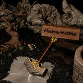 A 13cm solid metal Mjolnir hammer replica resting on a stone path next to a blacksmith anvil in a dark volcanic sand diorama.
