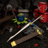 The complete Biggoron's Sword replica and its scabbard laid flat on a blacksmith diorama setup featuring red explosive barrels and a miniature anvil.