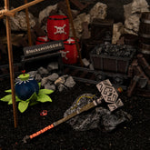Iron Sledgehammer replica beautifully displayed on coal, surrounded by a Bomb Flower, minecart, and explosive barrels.
