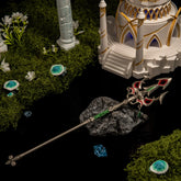 The complete Zelda Lightscale Trident metal prop resting on a dark stone amidst a miniature Zora's Domain diorama with luminous stones and moss.