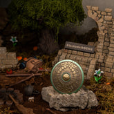 Traveler's Shield replica displayed on a rock in a ruined campsite, surviving a Bokoblin ambush near a kicked-over cooking pot.