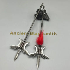 Anime-style zinc alloy weapon replicas with intricate designs and red fur, display on gray surface