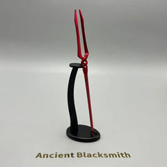 Red zinc alloy anime-style weapon replica on display stand, Ancient Blacksmith text below