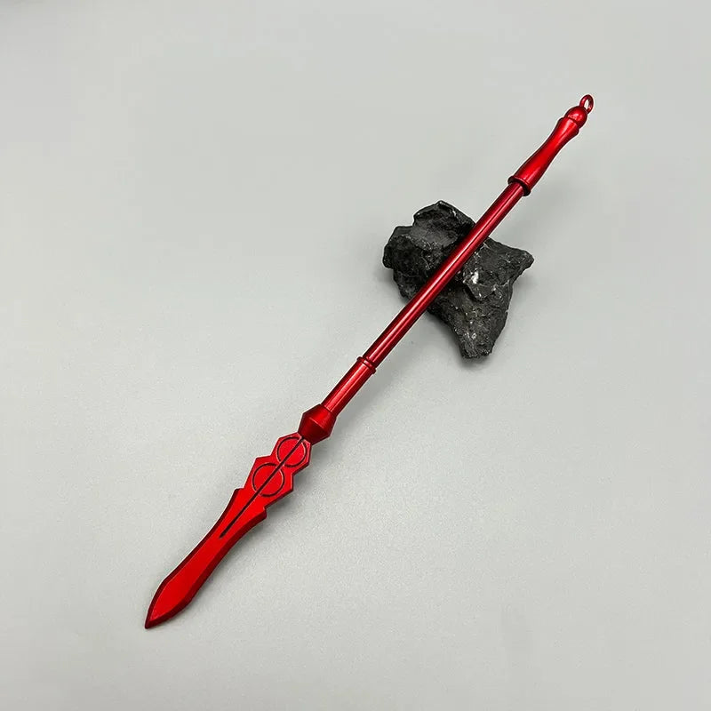 Red anime-style zinc alloy spear replica on gray surface with black rock, collectible display.