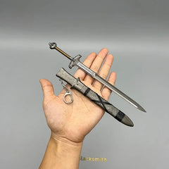 Hand holding 1:6 anime zinc alloy sword replica with sheath, collectible for display or cosplay
