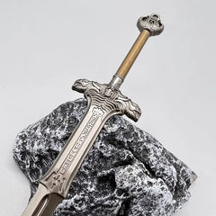 Anime-style zinc alloy sword replica on textured rock, collectible cosplay weapon