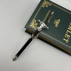 Anime-style black zinc alloy sword replica with silver accents on green Hamlet book