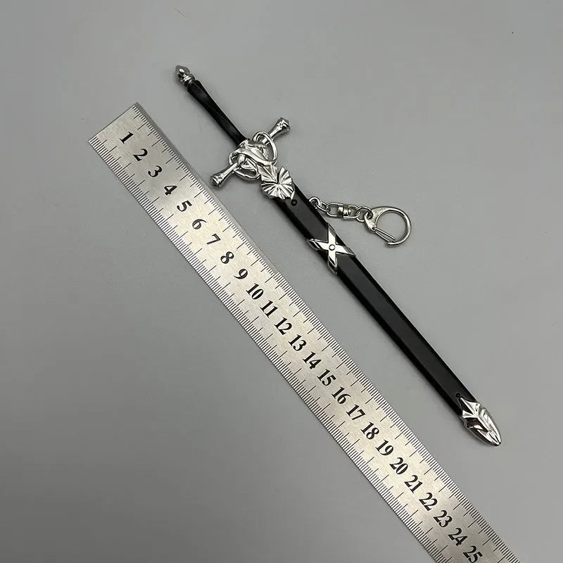 Anime-style zinc alloy sword replica keychain beside metal ruler on gray background