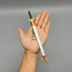 Hand holding 1:6 anime-style zinc alloy sword keychain with red and gold details, BlacksmithSONG collectible.