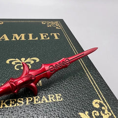 Red anime-style zinc alloy replica sword on Hamlet book for display or cosplay collectible