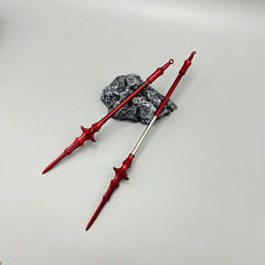 Red 1:6 anime-style zinc alloy spear replicas by BlacksmithSONG, displayed on a stone
