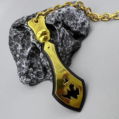 Gold anime-style zinc alloy weapon replica keychain on stone, BlacksmithSONG collectible.