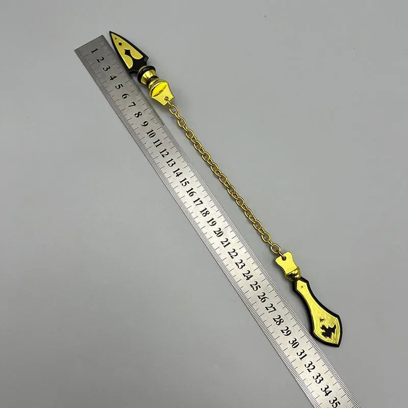 Anime-style zinc alloy weapon replica with gold chain beside ruler, collectible display.