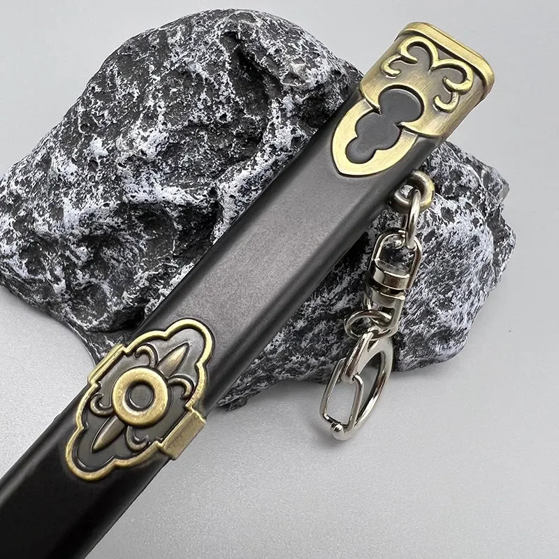 Anime-style zinc alloy weapon replica keychain with gold accents on stone, BlacksmithSONG collectible