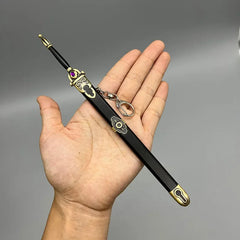 Hand holding a 1:6 anime-style zinc alloy sword replica with gold accents and keychain