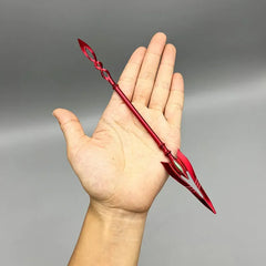 Anime-style red zinc alloy spear mini replica displayed on a hand, collectible for cosplay