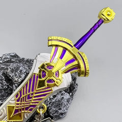 Purple and gold anime-style zinc alloy sword replica collectible displayed on a rock
