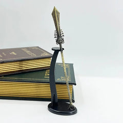 Anime-style zinc alloy spear replica on stand, display with hardcover books, collectible decor