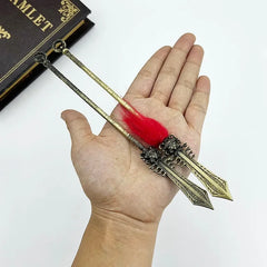 Hand holding two 1:6 scale anime-style zinc alloy weapon replicas with red tassels