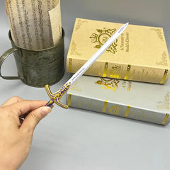 Hand holding 1:6 anime-style zinc alloy sword replica by BlacksmithSONG near vintage books
