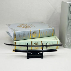 1:6 anime-style katana zinc alloy replica on display stand with decorative books, BlacksmithSONG collectible.
