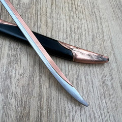 1:6 scale anime-style zinc alloy sword replica with black and bronze sheath on wood surface