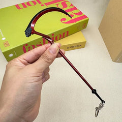 Hand holding 1:6 anime-style red scythe zinc alloy weapon replica collectible from BlacksmithSONG