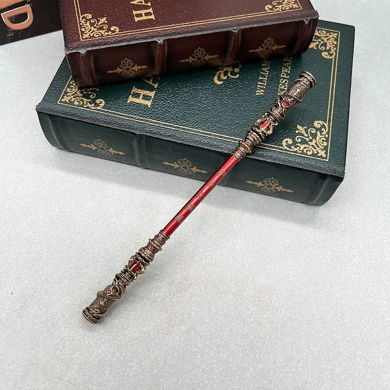 Anime-style red zinc alloy replica wand on vintage books, collectible cosplay accessory