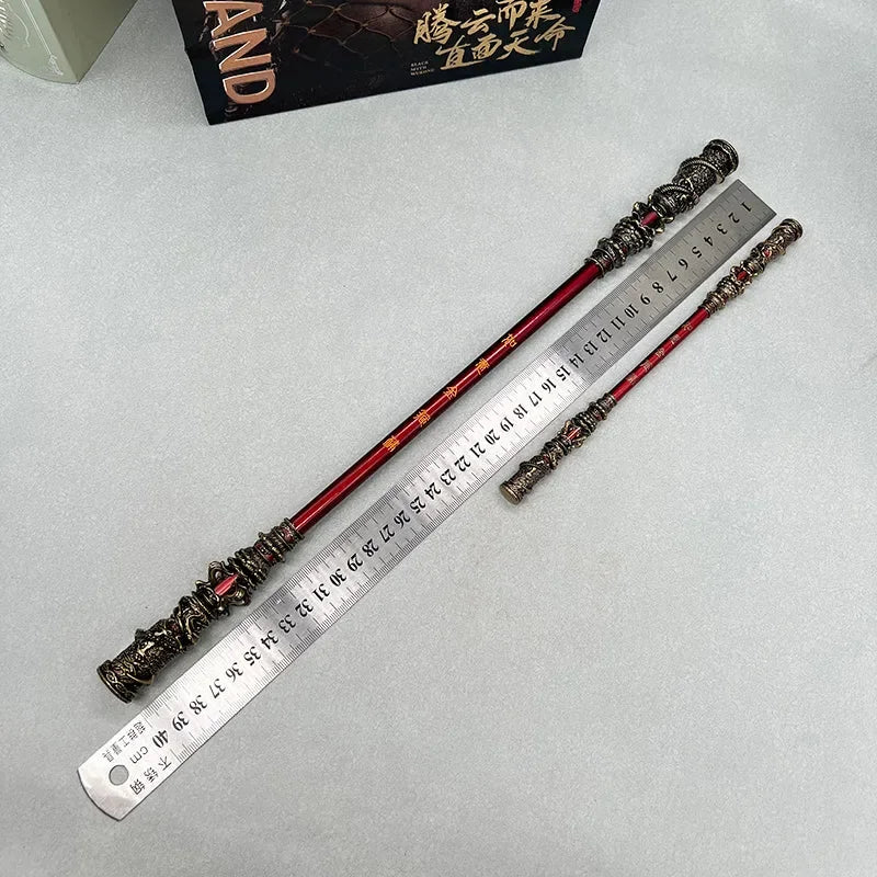Anime-style zinc alloy weapon replicas with intricate gold and red detailing beside a ruler