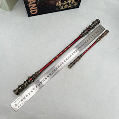 Anime-style zinc alloy weapon replicas with intricate gold and red detailing beside a ruler