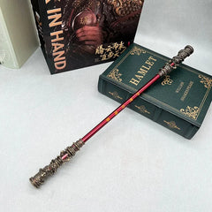 Anime-style zinc alloy staff replica with ornate ends, displayed on classic book