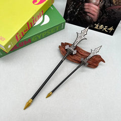 Two anime-style zinc alloy weapon replicas on a wooden stand, collectible display.