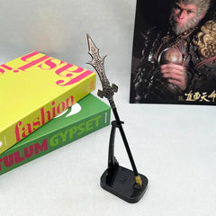Anime-style 1:6 zinc alloy spear replica on stand, with books and display backdrop.