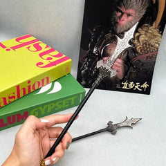 Anime-style zinc alloy weapon replica held in hand, display books and fantasy art in background.
