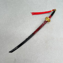 1:6 scale anime-style zinc alloy katana replica with red and black blade, gold accents, and red tassel