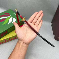 Anime-style 1:6 zinc alloy katana replica with red and black design held in hand, BlacksmithSONG collectible.