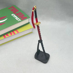 1:6 anime-style zinc alloy katana replica with red details on display stand, near books
