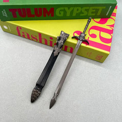 Anime-style 1:6 zinc alloy sword replica with detailed sheath on a tabletop, BlacksmithSONG collectible.